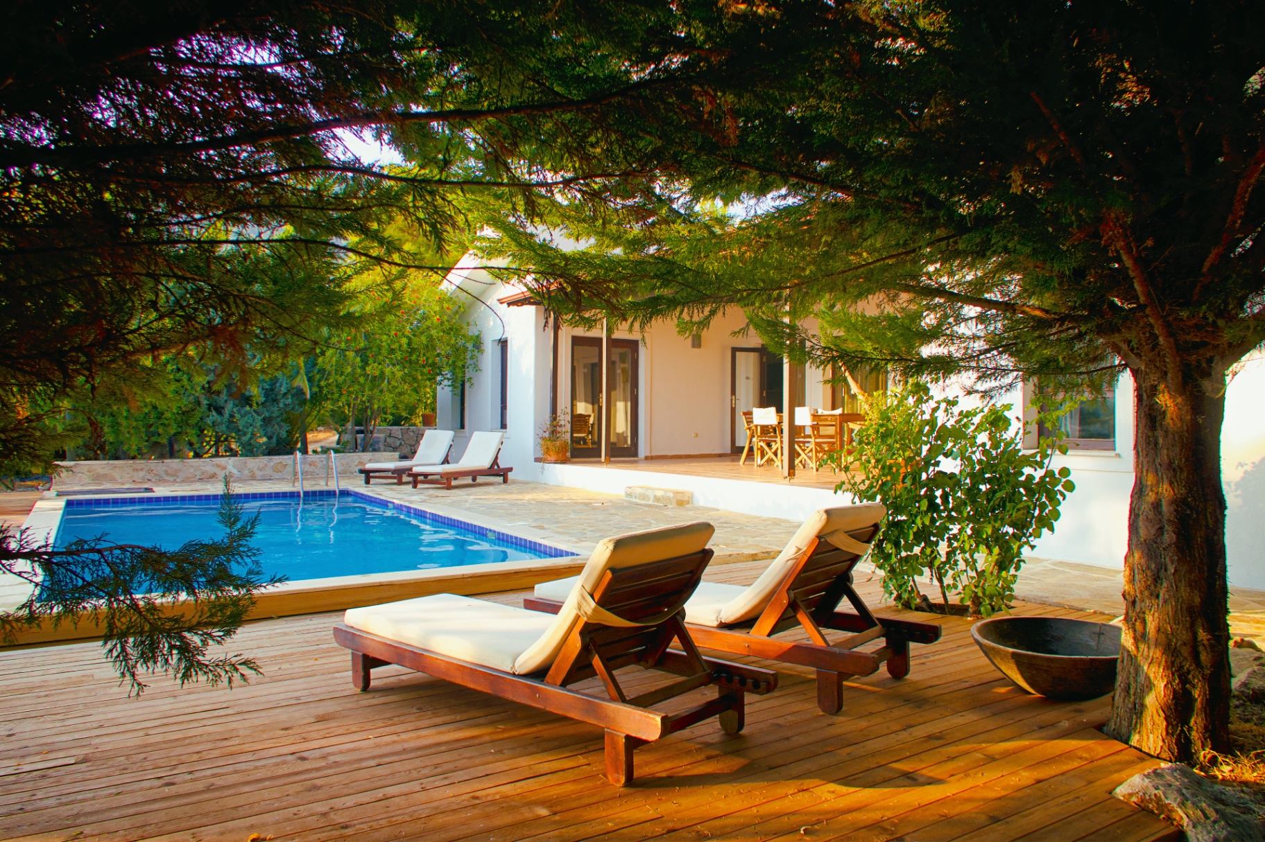 Villa Papatya pool and terrace framed by cypress trees at golden hour